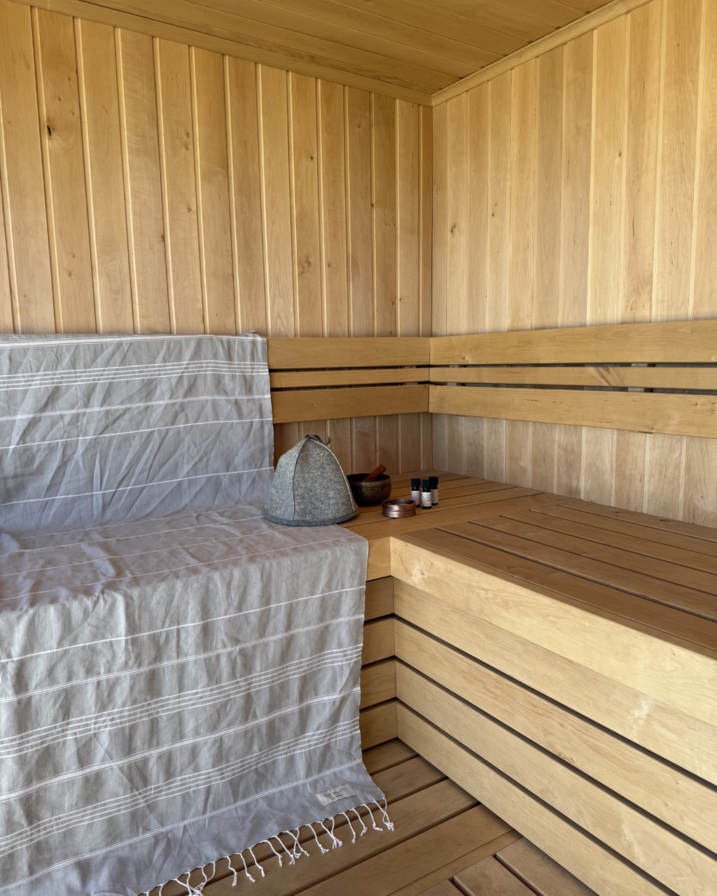 EIR studio 100% certified organic cotton hammam towel/peshtemal/turkish towel and 100% virgin wool sauna hat in use in sauna